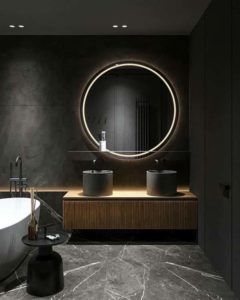 круглое зеркало на черной стене в ванной